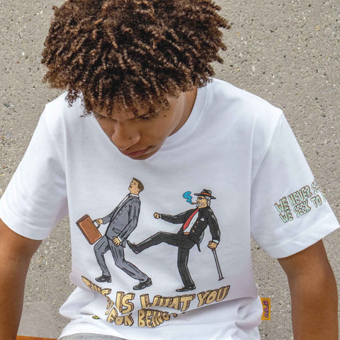 Person wearing a white t-shirt with graphic design and text.