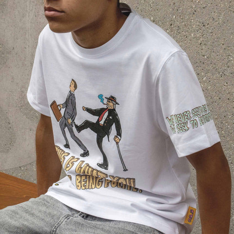 Person wearing a white t-shirt with graphic design and text.