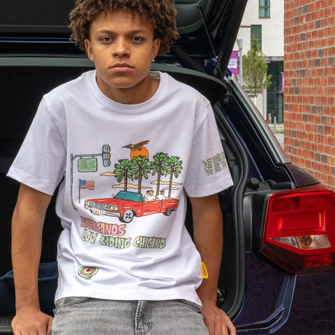 Allmosst  Americanos Graphic Custom T-shirt White. On a model sitting on a Car trunk 