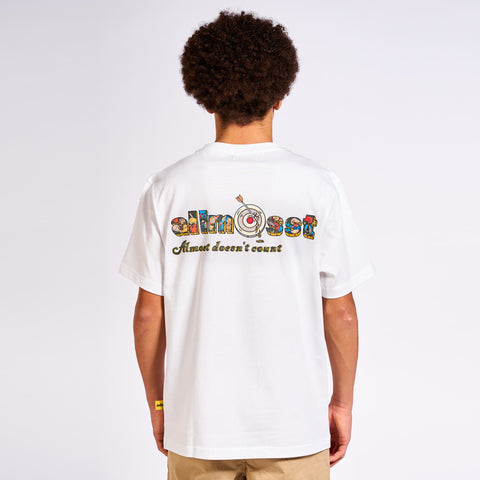A short-sleeved white Undefeated Champ T-shirt